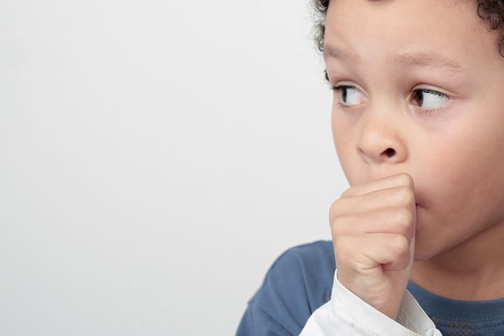 little boy sucking thumb on white background stock photo